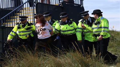 Environmental activists disrupt play at British Open by throwing orange substance on 17th green